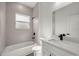 Bright bathroom featuring a tub and shower, white vanity, and complementary fixtures at 142 Guava Pass, Ocklawaha, FL 32179