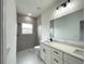 Modern bathroom features a shower, quartz counters and double sink vanity at 142 Guava Pass, Ocklawaha, FL 32179