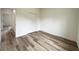 A spacious bedroom with wood-style floors and a closet offers a bright and welcoming space at 142 Guava Pass, Ocklawaha, FL 32179