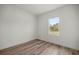 Cozy bedroom featuring wood-look floors, a bright window, and ample natural light at 142 Guava Pass, Ocklawaha, FL 32179