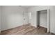 Simple bedroom with wood-look floors, a walk-in closet, and an open doorway at 142 Guava Pass, Ocklawaha, FL 32179
