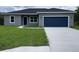Charming single-story home with a well-maintained lawn and a two-car garage at 142 Guava Pass, Ocklawaha, FL 32179