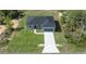 New construction home featuring a dark roof, concrete driveway, and an attached garage at 142 Guava Pass, Ocklawaha, FL 32179