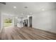 Open-concept kitchen featuring stainless steel appliances, an island with breakfast bar seating, and sliding glass doors at 142 Guava Pass, Ocklawaha, FL 32179