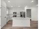 This kitchen features white cabinets, stainless steel appliances, and a center island with seating at 142 Guava Pass, Ocklawaha, FL 32179