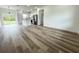 Open-concept living room with modern kitchen, stainless appliances, and sleek cabinetry at 142 Guava Pass, Ocklawaha, FL 32179