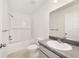 Bathroom with white subway tile, updated vanity, tub with shower, and tile floors at 14690 Sw 24Th. Pl, Ocala, FL 34481