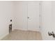 Laundry room with white door and wood look flooring at 14690 Sw 24Th. Pl, Ocala, FL 34481