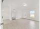 Open living space with sleek tile flooring, providing a seamless transition to the adjoining hallway and bedroom at 14690 Sw 24Th. Pl, Ocala, FL 34481