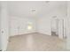 View of the bright living room shows an entry door and neutral tile floors at 14690 Sw 24Th. Pl, Ocala, FL 34481