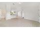 Bright, airy living space with tile floors and white walls, blending seamlessly into the kitchen and hallway at 14690 Sw 24Th. Pl, Ocala, FL 34481