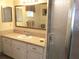 Bathroom vanity with mirror and sink next to a glass door shower with neutral tan colors at 14695 Sw 112Th Cir, Dunnellon, FL 34432