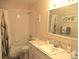 Well-lit bathroom with a tub, shower, tiled walls, and vanity, offering a clean and functional space at 14695 Sw 112Th Cir, Dunnellon, FL 34432