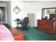 Bedroom with a desk, dresser, and green carpet flooring at 14695 Sw 112Th Cir, Dunnellon, FL 34432