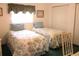 Bedroom view displaying twin beds, window with curtains, and closet with double doors at 14695 Sw 112Th Cir, Dunnellon, FL 34432