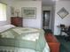 Cozy bedroom featuring a bed, dresser, and a workspace for added functionality at 14695 Sw 112Th Cir, Dunnellon, FL 34432