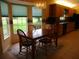 A sunny dining area provides a cozy place for meals with large windows offering a pleasant view at 14695 Sw 112Th Cir, Dunnellon, FL 34432