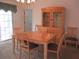 Dining area with wooden table and chairs next to a built-in cabinet at 14695 Sw 112Th Cir, Dunnellon, FL 34432