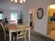Open concept dining room featuring a wooden table and seating with views into other living spaces at 14695 Sw 112Th Cir, Dunnellon, FL 34432