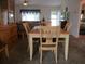 Dining area with wood table and seating with view into the living room and kitchen at 14695 Sw 112Th Cir, Dunnellon, FL 34432