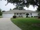 Charming single-story home with attached garage, well-manicured lawn, and welcoming curb appeal at 14695 Sw 112Th Cir, Dunnellon, FL 34432