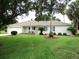 Charming single-story home featuring a manicured lawn and mature landscaping with a two car garage and neutral color palette at 14695 Sw 112Th Cir, Dunnellon, FL 34432