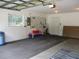 Spacious two car garage with a window and storage area to easily store your belongings at 14695 Sw 112Th Cir, Dunnellon, FL 34432