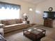 Inviting living room featuring comfortable seating and a glass-top coffee table at 14695 Sw 112Th Cir, Dunnellon, FL 34432