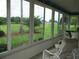 A beautiful outdoor view from a screened lanai provides the perfect spot for relaxation at 14695 Sw 112Th Cir, Dunnellon, FL 34432