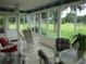 Bright sunroom with comfortable seating, expansive windows, and a serene outdoor view at 14695 Sw 112Th Cir, Dunnellon, FL 34432