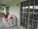 Cozy sunroom with a comfortable couch and large sliding glass doors, seamlessly blending indoor and outdoor living at 14695 Sw 112Th Cir, Dunnellon, FL 34432