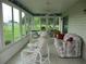 Inviting sunroom with ample seating, picturesque windows, and calming outdoor scenery at 14695 Sw 112Th Cir, Dunnellon, FL 34432