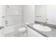 Bright bathroom featuring a vanity with solid surface countertop and shower-tub combo at 14698 Sw 20Th Pl, Ocala, FL 34481