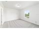 Bright bedroom featuring a large window, plush carpet, and light, neutral walls at 14698 Sw 20Th Pl, Ocala, FL 34481
