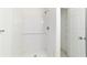 New shower with white tile and white base and shelving unit at 14698 Sw 20Th Pl, Ocala, FL 34481