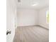 A bright bedroom with neutral carpet, white walls, and a window with a green view at 14885 Sw 23Rd Pl, Ocala, FL 34481