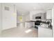 Kitchen with gray cabinetry, breakfast bar, and view into the living room at 14885 Sw 23Rd Pl, Ocala, FL 34481