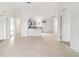 Bright, open-concept living room with white walls and tile flooring at 14885 Sw 23Rd Pl, Ocala, FL 34481