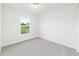 This bedroom features a window for natural light and neutral carpet at 14893 Sw 23Rd Pl, Ocala, FL 34481
