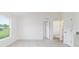 Bright bedroom with a large window, light wood floors, and ensuite bathroom at 14893 Sw 23Rd Pl, Ocala, FL 34481