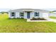 Well maintained one-story home with a gray roof, stucco exterior, and a verdant green lawn at 14893 Sw 23Rd Pl, Ocala, FL 34481