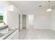 Bright kitchen features stainless steel sink, white cabinets, pantry, and light wood-look flooring at 14893 Sw 23Rd Pl, Ocala, FL 34481