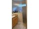 Bathroom featuring granite countertops, a privacy glass partition, and a tiled walk-in shower at 16023 Sw 14Th Avenue Rd, Ocala, FL 34473