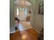 Inviting foyer with tile flooring and view of the front door, enhanced by a decorative chandelier at 16023 Sw 14Th Avenue Rd, Ocala, FL 34473