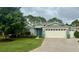 Charming single-story home with well-maintained landscaping, a large front lawn, and attached two-car garage at 16023 Sw 14Th Avenue Rd, Ocala, FL 34473