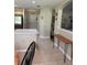 Open hallway view with tile flooring, arched doorways, and a wooden console table enhancing the interior's charm at 16023 Sw 14Th Avenue Rd, Ocala, FL 34473