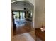 Bright living room with hardwood floors, a large area rug, and sliding glass doors to a screened lanai at 16023 Sw 14Th Avenue Rd, Ocala, FL 34473