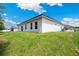 View of the back of the home and large backyard area, with lawn and landscaping at 162 Nw 42Nd Pl, Ocala, FL 34475