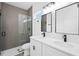 Elegant bathroom with dual sinks, quartz countertop, modern fixtures, and a glass-enclosed shower at 162 Nw 42Nd Pl, Ocala, FL 34475