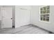 Bedroom features a window, closet, and modern gray laminate flooring at 162 Nw 42Nd Pl, Ocala, FL 34475